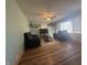 Bright living room features hardwood floors, a ceiling fan, and ample seating with natural light at 6346 Shelby St, Indianapolis, IN 46227