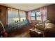 Cozy living room with wood paneling, hardwood floors, and comfortable seating by the window at 6346 Shelby St, Indianapolis, IN 46227