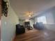 Bright living room features hardwood floors, a ceiling fan, and comfortable seating with natural light at 6346 Shelby St, Indianapolis, IN 46227