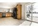 View of the kitchen with a large cabinet, sleek black appliances, and access to the outdoors at 6413 Green Grass Ln, Whitestown, IN 46075