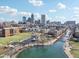 Overhead shot of the neighborhood, canal, park, and cityscape on a sunny day with blue skies at 645 Ellsworth St, Indianapolis, IN 46202