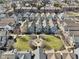 Stunning aerial view of colorful townhomes surrounding a well-manicured green space with a fire pit at 645 Ellsworth St, Indianapolis, IN 46202