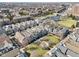 Aerial view of a neighborhood showcasing well-maintained homes, green spaces, and a nearby waterway at 645 Ellsworth St, Indianapolis, IN 46202