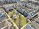 Aerial view showing a vibrant community with manicured lawns, mature trees, and a central green space at 645 Ellsworth St, Indianapolis, IN 46202
