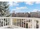 Balcony with white railings offering views of the lush landscaping and the neighborhood at 645 Ellsworth St, Indianapolis, IN 46202