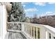 Balcony with white railings offering neighborhood views and lush green trees at 645 Ellsworth St, Indianapolis, IN 46202