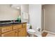 Bathroom featuring a light wood vanity with black countertop and shower with glass door at 645 Ellsworth St, Indianapolis, IN 46202