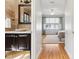 Half bath featuring a designer sink, granite countertops, decorative mirror, and travertine tile walls at 645 Ellsworth St, Indianapolis, IN 46202
