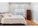 Cozy bedroom with natural light, wooden floors, and wooden dresser at 645 Ellsworth St, Indianapolis, IN 46202