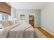Bedroom with natural light boasts a woven window shade, hardwood floors, and closet with white shelving at 645 Ellsworth St, Indianapolis, IN 46202