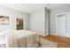 This bedroom boasts hardwood floors, white trim, closet with white shelving, and access to a second door at 645 Ellsworth St, Indianapolis, IN 46202