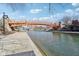 Scenic view of an orange pedestrian bridge over the canal and a walking path on a clear day at 645 Ellsworth St, Indianapolis, IN 46202