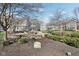 Beautifully landscaped community area with manicured lawn, brick patio, and inviting seating areas at 645 Ellsworth St, Indianapolis, IN 46202