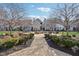 Community courtyard area featuring a stone fire pit, benches, manicured bushes, and several residential units at 645 Ellsworth St, Indianapolis, IN 46202