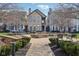 Community courtyard area featuring a stone fire pit, benches, manicured bushes, and several residential units at 645 Ellsworth St, Indianapolis, IN 46202
