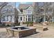 Courtyard featuring benches, landscaping, and nearby townhomes at 645 Ellsworth St, Indianapolis, IN 46202