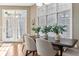 Bright dining room with hardwood floors, a large window, and view of the backyard at 645 Ellsworth St, Indianapolis, IN 46202