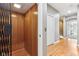 Residential elevator with wood paneling opening into a hallway with hardwood floors at 645 Ellsworth St, Indianapolis, IN 46202