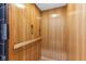 Interior view of a residential elevator featuring wood paneling and safety gate at 645 Ellsworth St, Indianapolis, IN 46202