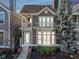 Charming two-story home featuring a private balcony, bay window, and beautifully landscaped front yard at 645 Ellsworth St, Indianapolis, IN 46202