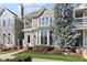 Beautiful two-story home with a balcony, bay windows, and lush landscaping at 645 Ellsworth St, Indianapolis, IN 46202