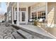 Charming front porch with stone steps, comfortable seating, and beautiful landscaping at 645 Ellsworth St, Indianapolis, IN 46202