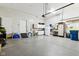 Spacious garage with painted floor and ample storage featuring slat wall, sink and other accessories at 645 Ellsworth St, Indianapolis, IN 46202
