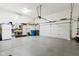 Spacious garage with painted floor and ample storage featuring slat wall, sink and other accessories at 645 Ellsworth St, Indianapolis, IN 46202
