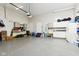 Spacious garage with painted floor and ample storage featuring slat wall, sink and other accessories at 645 Ellsworth St, Indianapolis, IN 46202