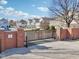 Gated community entrance with secure access, brick pillars, and well-maintained landscaping at 645 Ellsworth St, Indianapolis, IN 46202