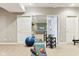 Bright home gym features mirrored wall, carpet flooring, and includes fitness equipment at 645 Ellsworth St, Indianapolis, IN 46202