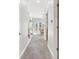 Hallway leads to a bright living space with a fireplace, neutral walls, and plush carpeting throughout at 645 Ellsworth St, Indianapolis, IN 46202