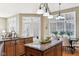 Kitchen featuring wood cabinets, granite countertops, hardwood floors, and an adjacent dining area at 645 Ellsworth St, Indianapolis, IN 46202