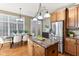Kitchen featuring wood cabinets, granite countertops, stainless appliances, hardwood flooring, and island at 645 Ellsworth St, Indianapolis, IN 46202