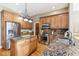 Well-equipped kitchen with stainless steel appliances, granite countertops, wood cabinets, and a kitchen island at 645 Ellsworth St, Indianapolis, IN 46202