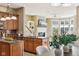 Modern kitchen with wood cabinets, island, granite counters, and stainless steel appliances at 645 Ellsworth St, Indianapolis, IN 46202