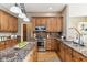 Open kitchen featuring granite counters, wood cabinets, stainless appliances and hardwood flooring at 645 Ellsworth St, Indianapolis, IN 46202