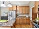 Kitchen with wood cabinets, stainless appliances, granite counters, hardwood flooring, and kitchen island at 645 Ellsworth St, Indianapolis, IN 46202