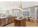 Open kitchen with granite counters and island, stainless steel appliances, hardwood floors, and dining area at 645 Ellsworth St, Indianapolis, IN 46202