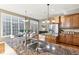 Bright kitchen with hardwood floors, wood cabinets, granite countertop, island and stainless steel appliances at 645 Ellsworth St, Indianapolis, IN 46202