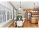 View of the kitchen and dining area with lots of natural light and wood floors at 645 Ellsworth St, Indianapolis, IN 46202