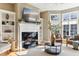 Living room with fireplace, built-in shelves and large windows at 645 Ellsworth St, Indianapolis, IN 46202