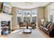 Bright living room featuring a fireplace, large windows, and comfortable seating at 645 Ellsworth St, Indianapolis, IN 46202