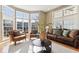 Sunlit living room features large windows, hardwood floors, and elegant furniture at 645 Ellsworth St, Indianapolis, IN 46202