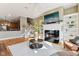 Open-concept living room with fireplace, built-in shelving, and view to kitchen and staircase at 645 Ellsworth St, Indianapolis, IN 46202