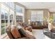 Inviting living room filled with natural light, hardwood floors and comfortable leather furniture at 645 Ellsworth St, Indianapolis, IN 46202