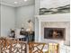 Bright living room with a fireplace and a built-in desk at 645 Ellsworth St, Indianapolis, IN 46202