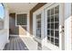 Spacious patio features white railings with french door access and light wood floors at 645 Ellsworth St, Indianapolis, IN 46202