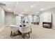Bright rec room boasts a glass dining table, exercise equipment, and versatile spaces at 645 Ellsworth St, Indianapolis, IN 46202