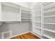 Walk-in closet with hardwood floors and white custom shelving providing lots of storage at 645 Ellsworth St, Indianapolis, IN 46202